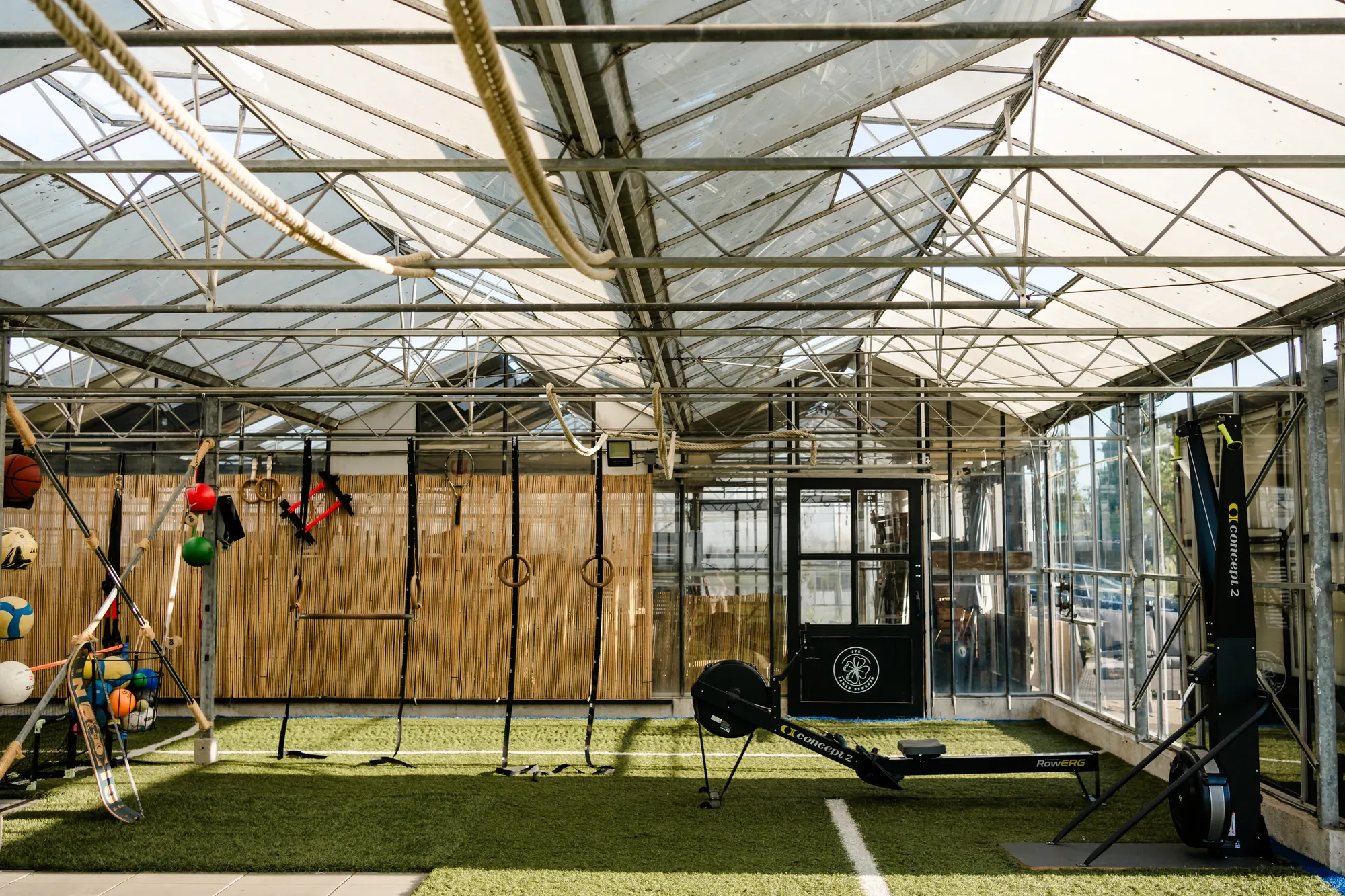 Binnenruimte met kunstgras en trainingsmateriaal